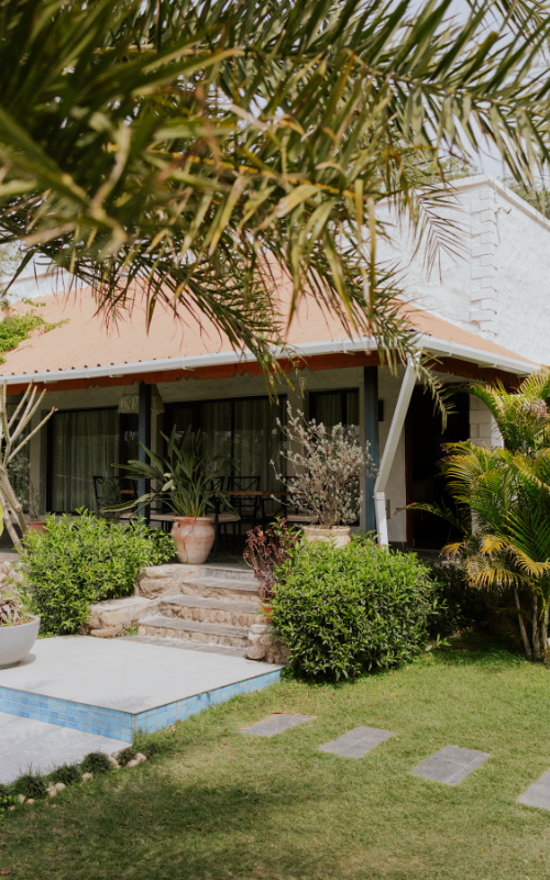 Farm cottage with palm trees and pool at Forest Hill Resort