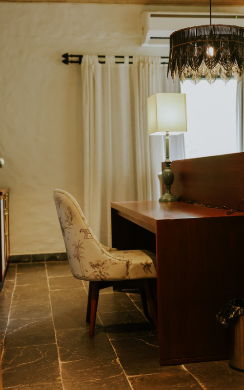 FHR Wilderness Lodge — study nook with vintage chair and macramé chandelier
