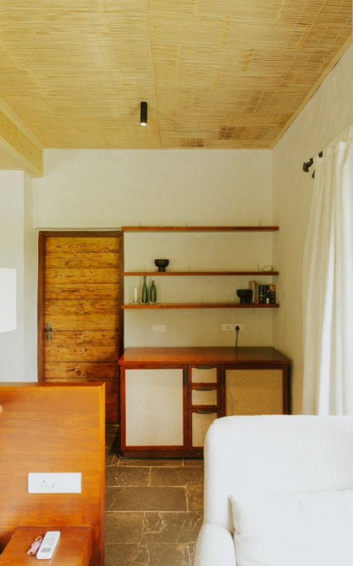 FHR Wilderness Lodge — living area with wooden shelving and rustic door